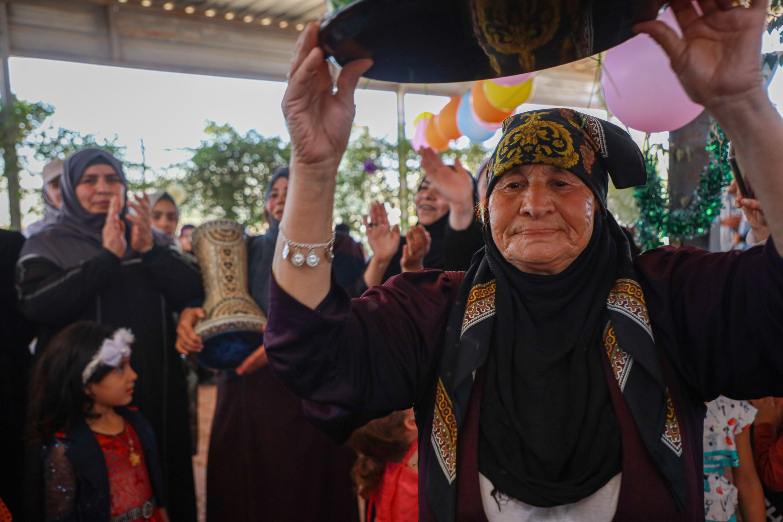 Um Ayman, 76, dances and shares Syrian stories as part of an activity organized in Zaatari camp to celebrate traditions normally carried out during weddings. ; Zaatari refugee camp is home to 81000 Syrian refugees. UNHCR manages the camp in coordination with the Jordanian Government.